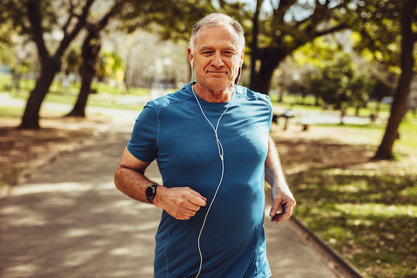 Cheerful senior man jogging