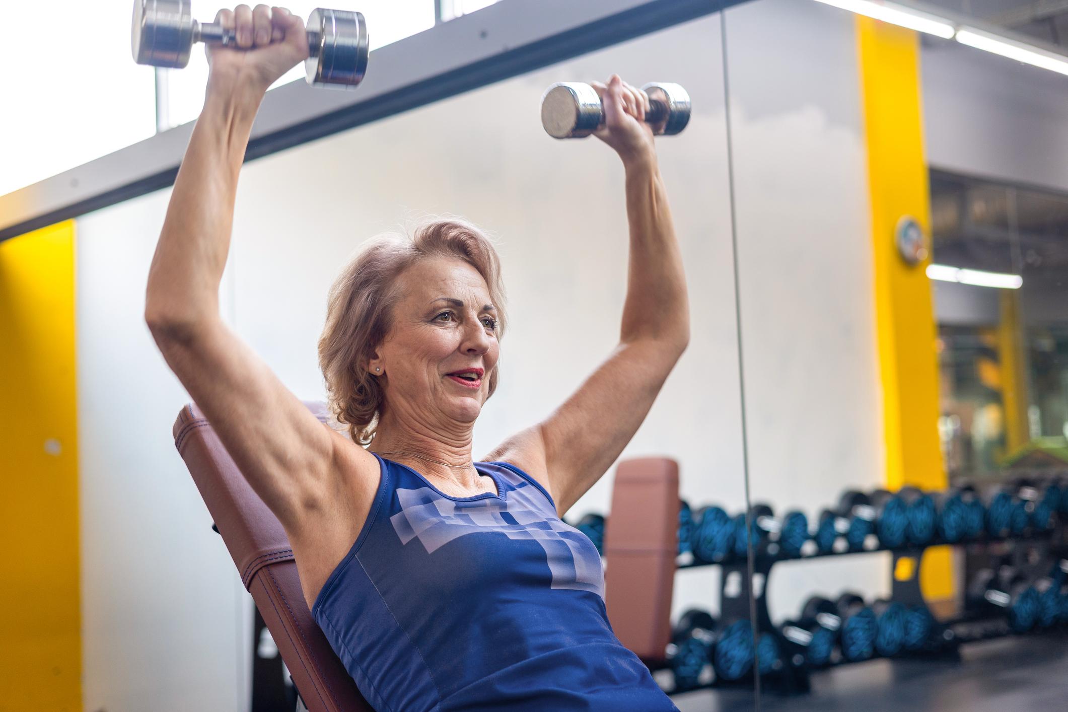 Active older adult performing strength training to help prevent muscle loss with age and maintain strength and independence.